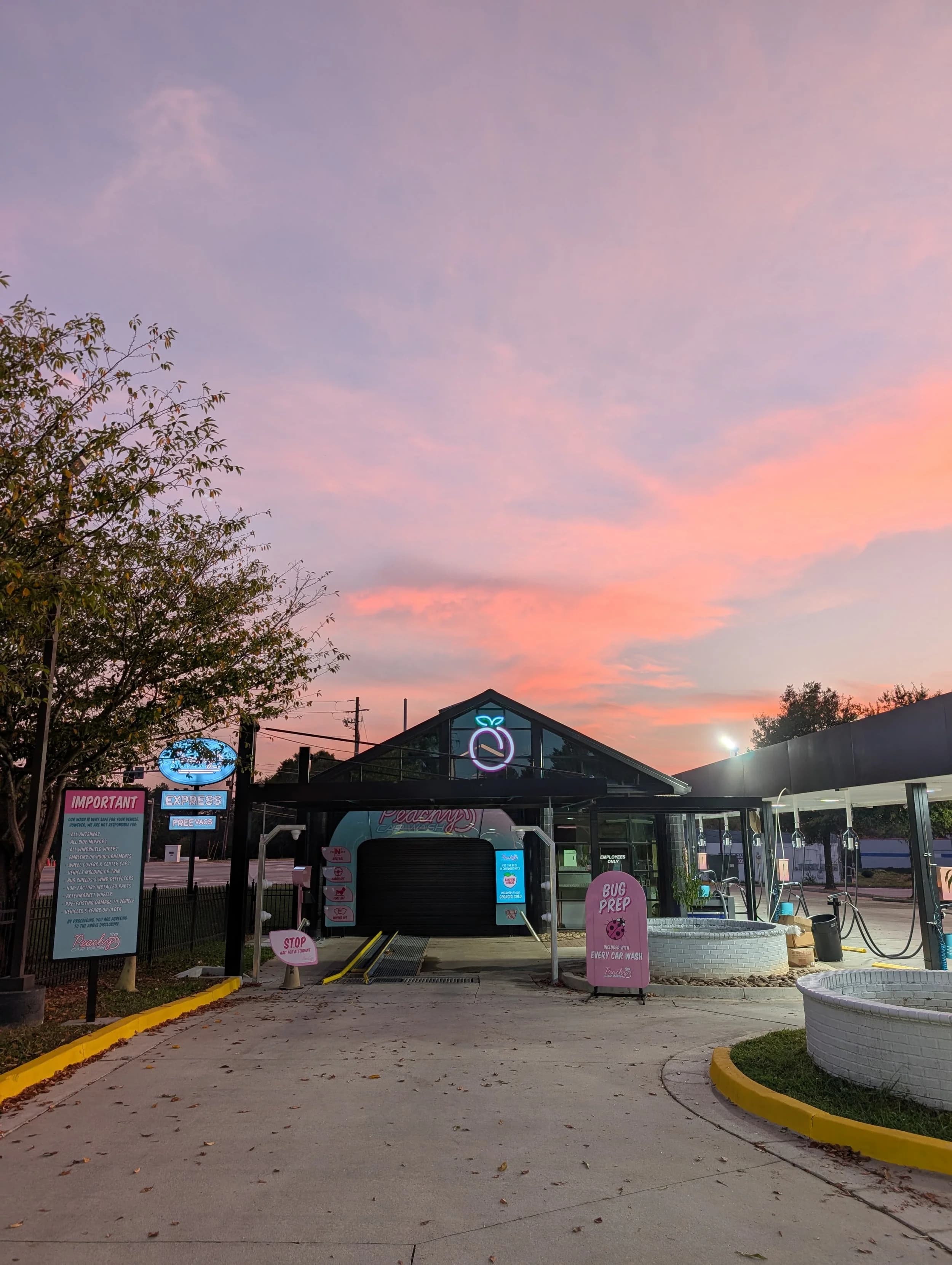 Peachy Car Wash lit up at dusk